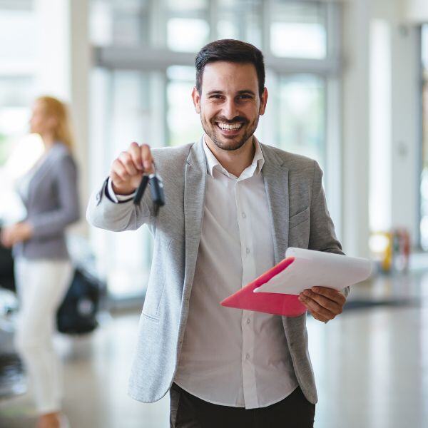 Car salesman showing off some car keys