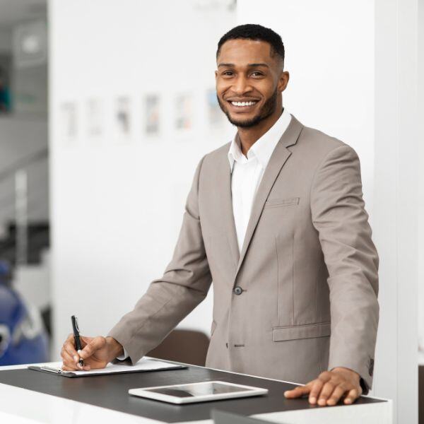 Salesman standing at desk